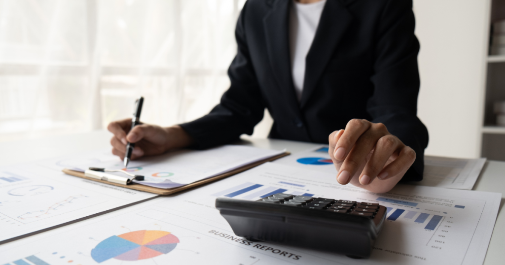 Business professional analyzing financial reports with a calculator, ensuring accurate quantity estimation for cost control and project success.